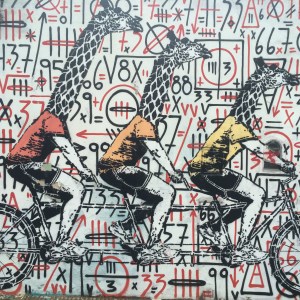 The giraffes are a stencil put over the original piece. Once a piece is finished, it belongs to the streets and is open to additions.